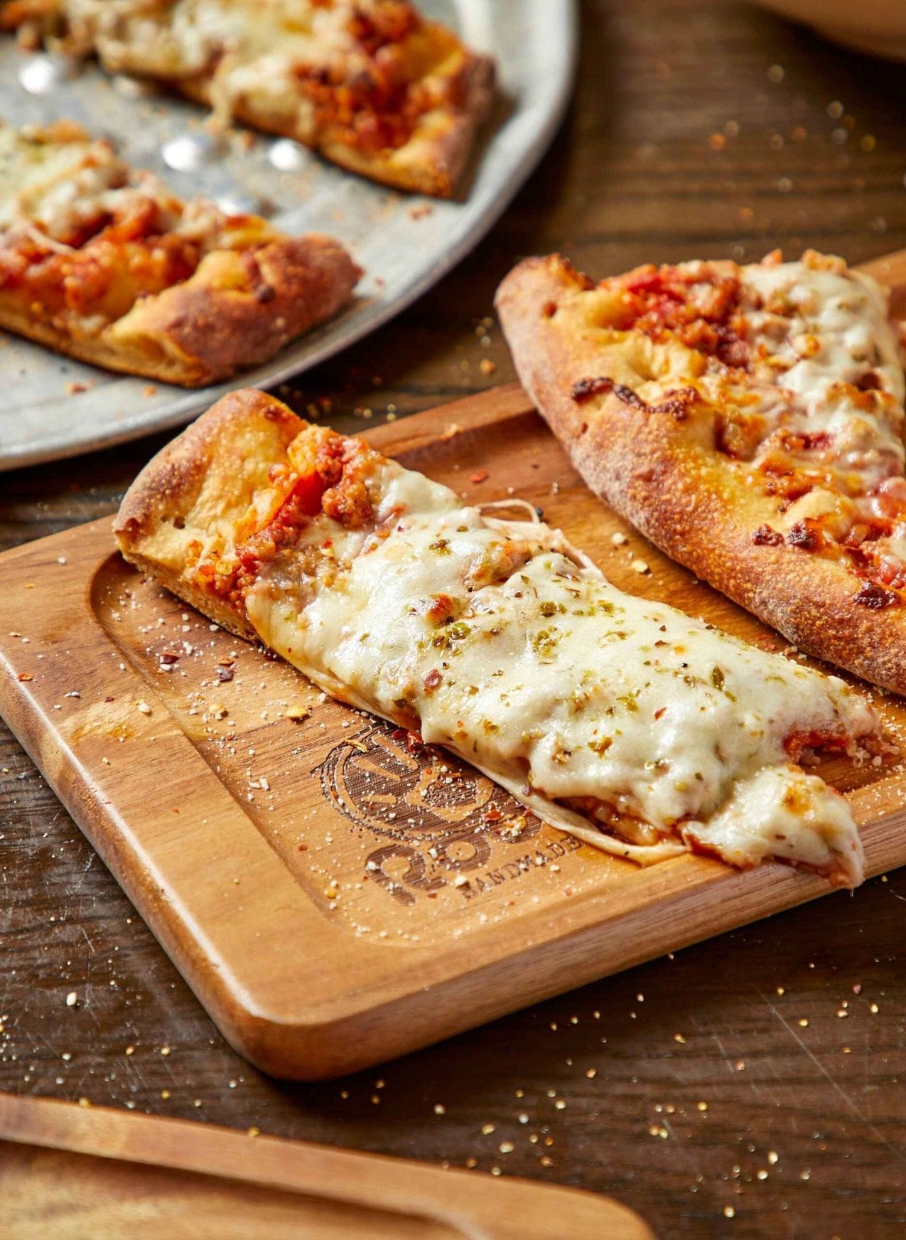 Roots Handmade Pizza's Quad City style pizza is cut into strips using giant scissors. 