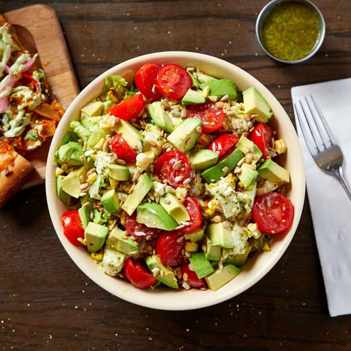 The tomato avocado and fresh mozzarella salad is a staple at Roots Handmade Pizza